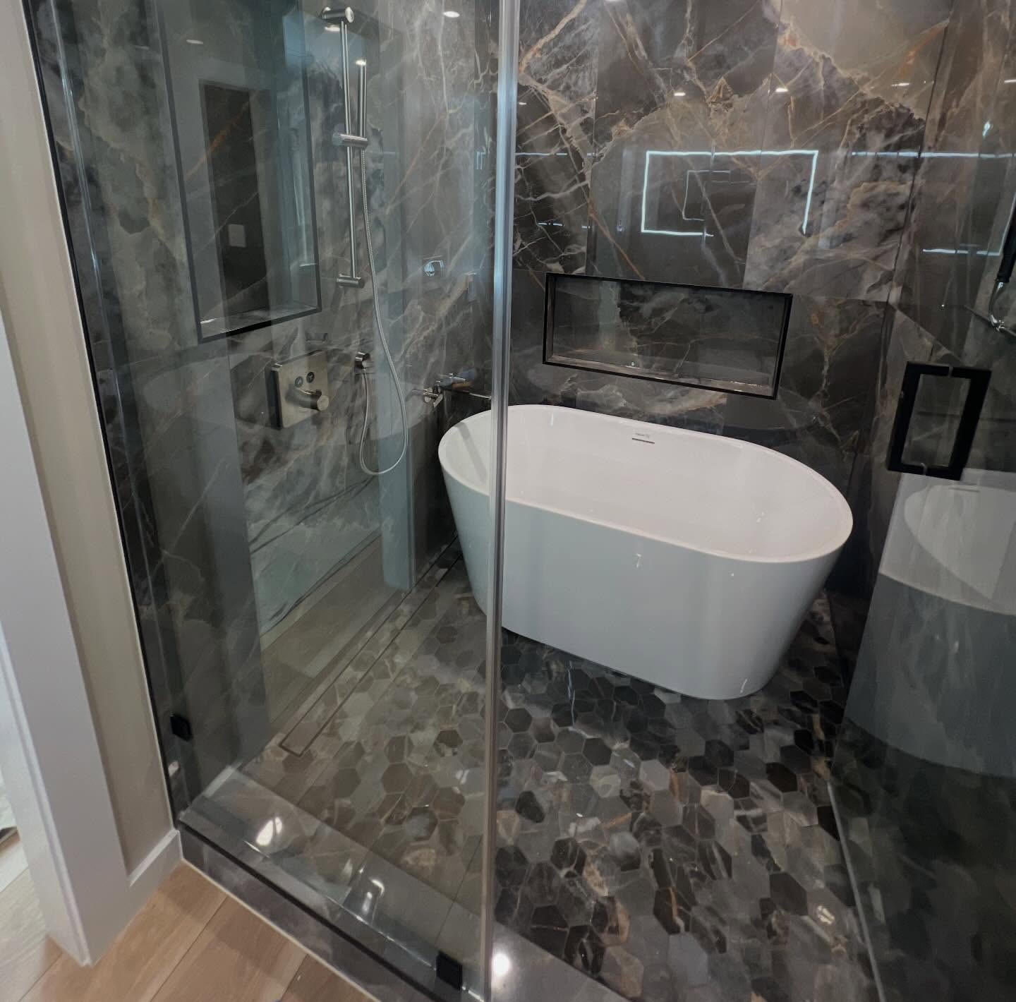Complete bathroom remodel designed by the homeowner which we brought to life with new shower, tub, tiles, and more
