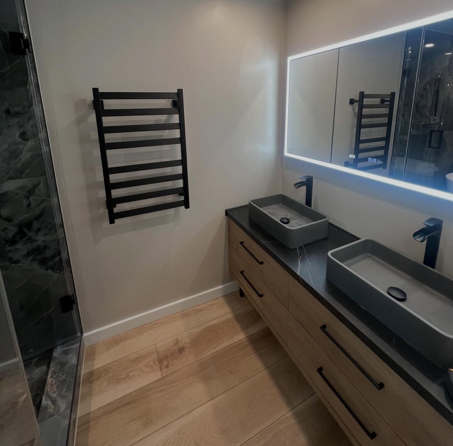 Complete bathroom remodel designed by homeowner which we brought to life with new vanity, lighting, mirror, paint, and more
