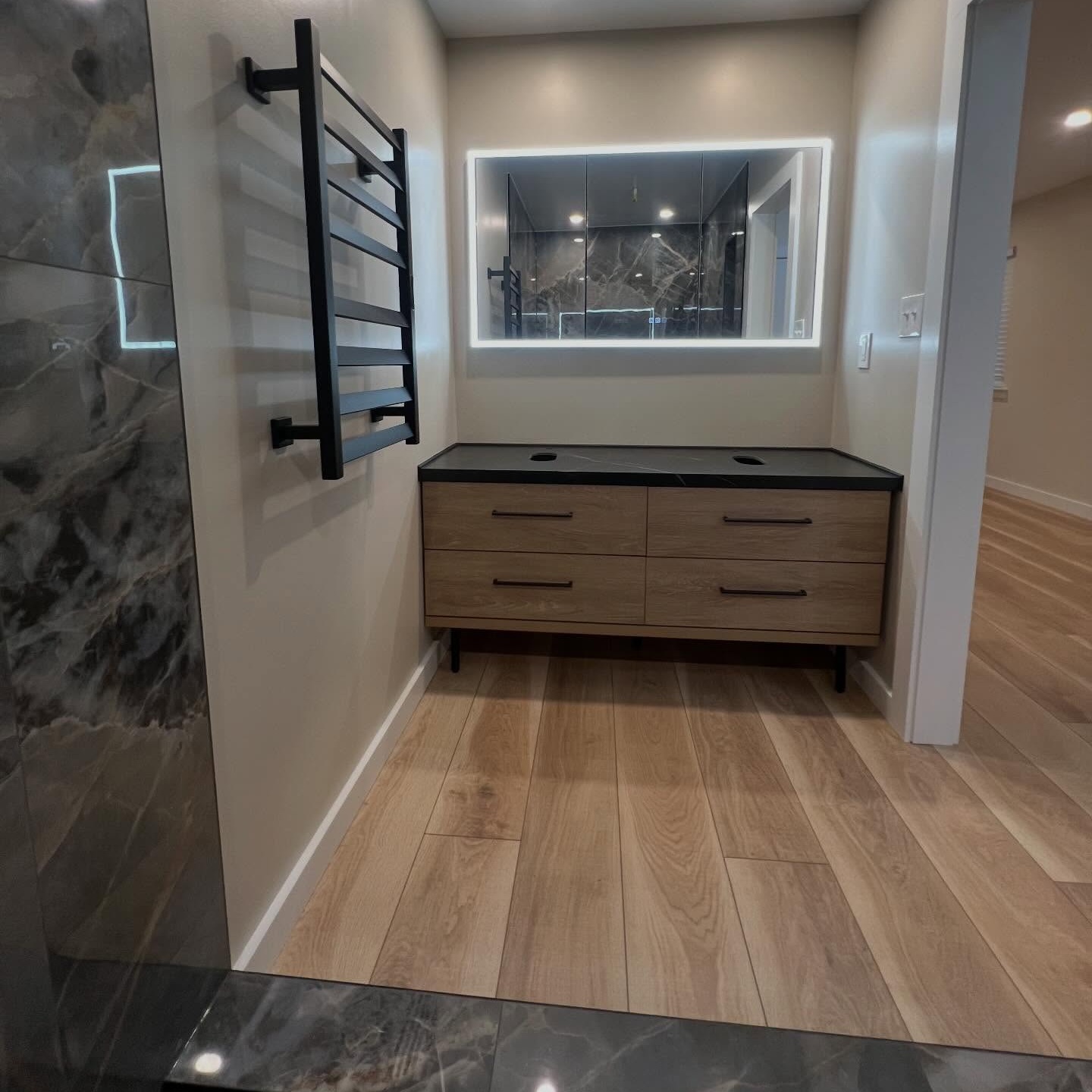 Complete bathroom remodel designed by homeowner which we brought to life with new vanity, lighting, mirror, paint, and more